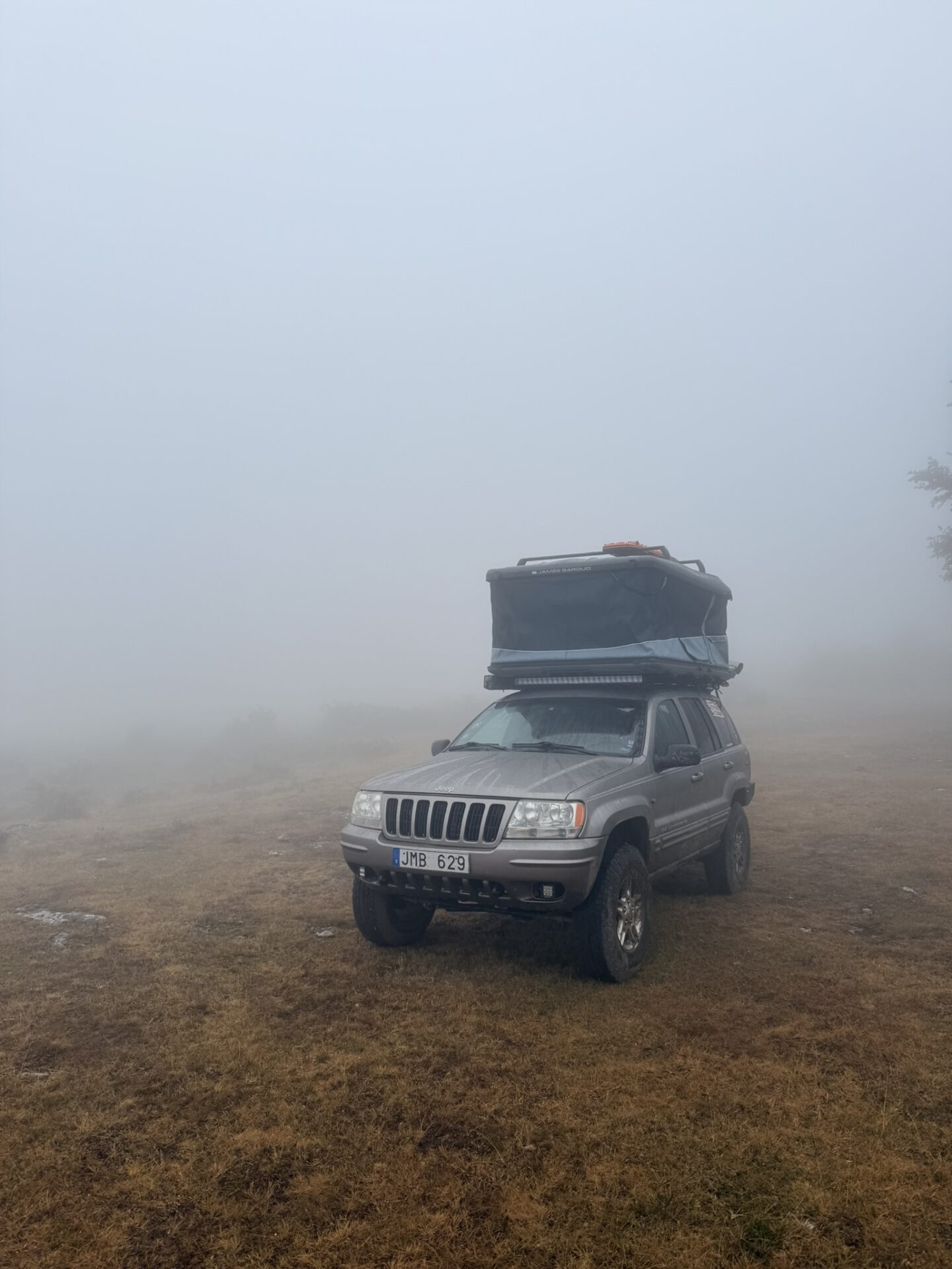 Jeep Grand Cherokee WJ WG 1999 with James Baroud Odyssey Nordic Size L roof top tent camping in spain. Misty moutnains.